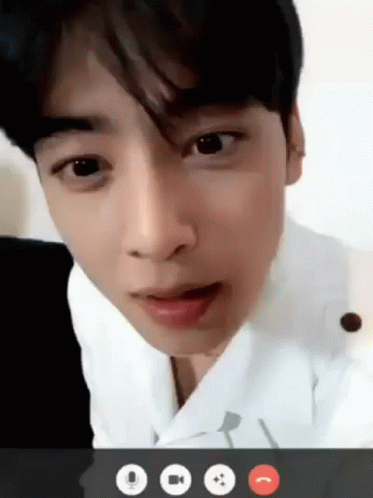 A Young Man Is Talking On A Video Call With A Microphone . GIF