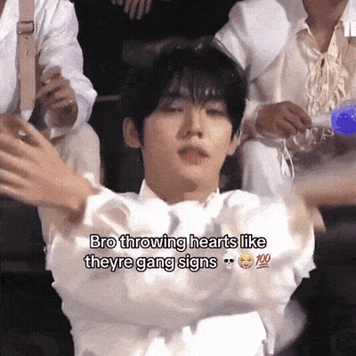 A Young Man Is Throwing Hearts Like Theyre Gang Signs GIF