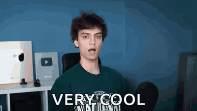 A Young Man Is Wearing A Green Shirt That Says `` Very Cool '' On It . GIF