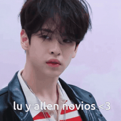 A Young Man Is Wearing A Leather Jacket And A Striped Shirt With The Words Lu Y Allen Novios < 3 On The Bottom GIF