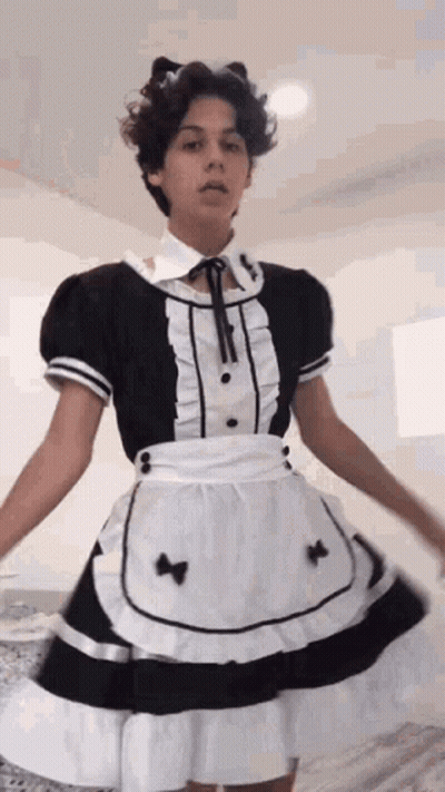 A Young Man Is Wearing A Maid Costume And A Cat Ear Headband . GIF