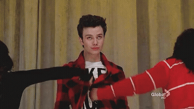 A Young Man Is Wearing A T-Shirt That Says `` Likes Boys '' And A Red Plaid Jacket . GIF