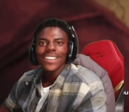 A Young Man Is Wearing Headphones And Smiling While Sitting In A Red Chair . GIF