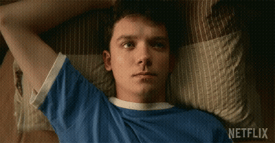 A Young Man Laying On A Bed With Netflix Written On The Bottom GIF
