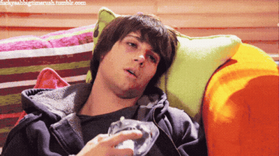 A Young Man Laying On A Couch With A Bottle Of Water In His Hand GIF