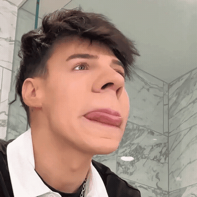 A Young Man Making A Face With His Tongue Out GIF