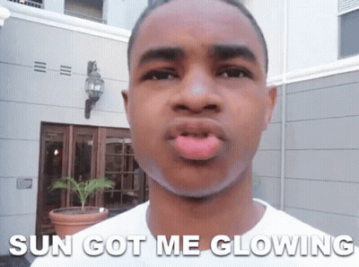 A Young Man Making A Funny Face With The Words Sun Got Me Glowing Below Him GIF