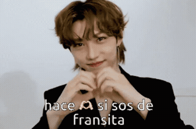 A Young Man Making A Heart With His Hands And The Words Hace Si Sos De Fransita GIF