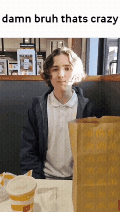 A Young Man Sits At A Table With A Mcdonald 'S Bag And A Cup GIF