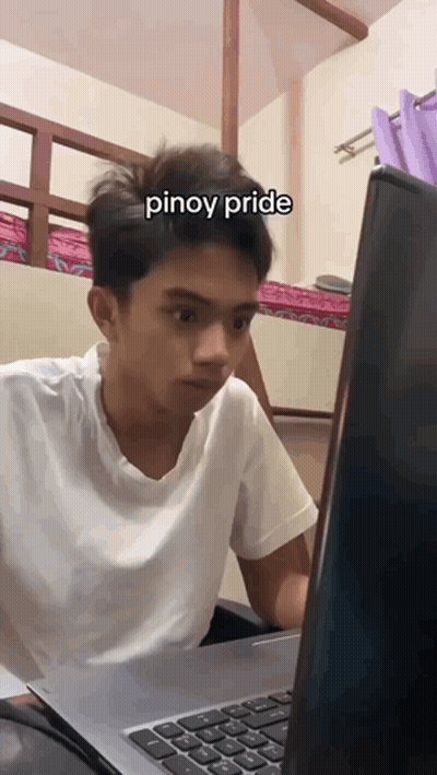 A Young Man Sitting In Front Of A Laptop With The Word Pinoy Pride Written On His Face GIF