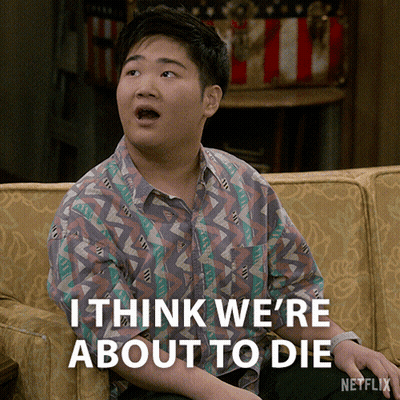A Young Man Sitting On A Couch With The Words " I Think We 'Re About To Die " Below Him GIF