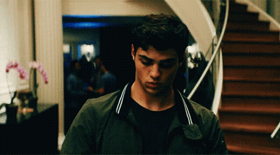 A Young Man Standing In Front Of A Staircase Looking Down GIF
