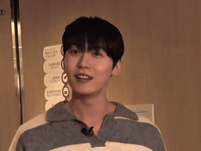 A Young Man Stands In Front Of A Sign That Says ' Elevator ' On It GIF