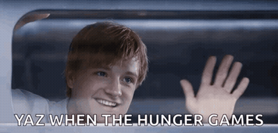 A Young Man Waving Out Of A Window With Yaz When The Hunger Games Below Him GIF