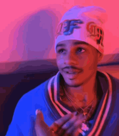 a young man wearing a beanie with the letter ff on it