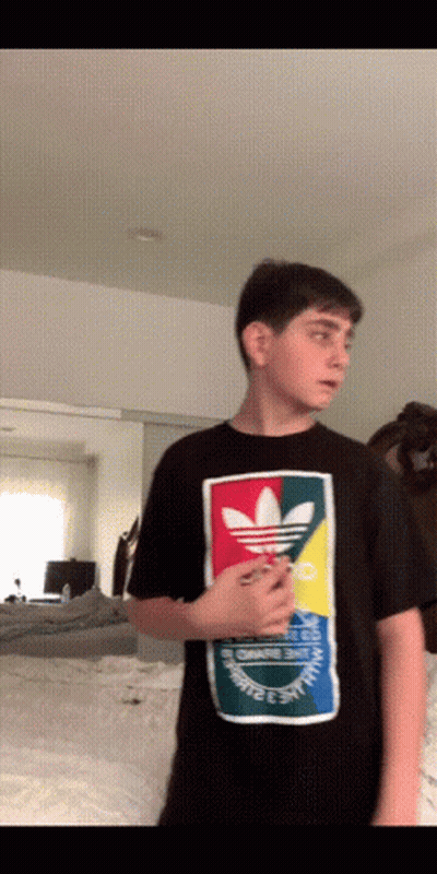 A Young Man Wearing A Black Adidas Shirt GIF