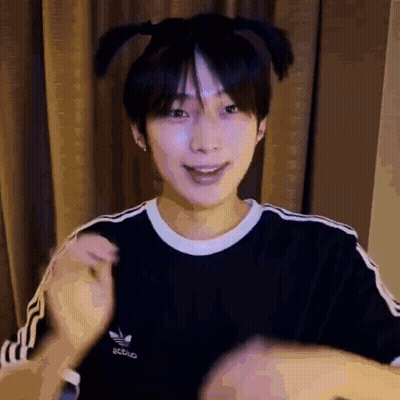 A Young Man Wearing A Black Adidas T-Shirt Is Making A Funny Face . GIF