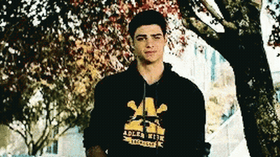 A Young Man Wearing A Black Adler High Hoodie GIF