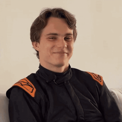 A Young Man Wearing A Black And Orange Jacket With The Letter K On The Sleeves GIF