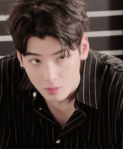 A Young Man Wearing A Black And White Striped Shirt GIF
