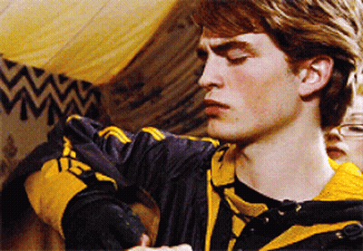 A Young Man Wearing A Black And Yellow Striped Shirt With The Letter H On It GIF