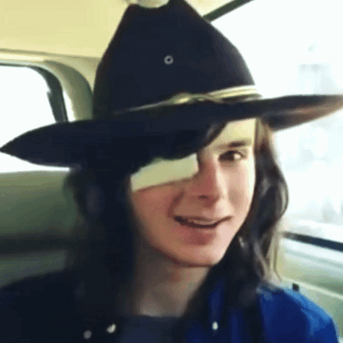 A Young Man Wearing A Black Cowboy Hat With A Bandage On His Eye GIF