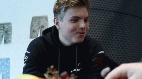 A Young Man Wearing A Black Hoodie That Says " I Am By " On It GIF