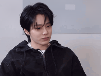 A Young Man Wearing A Black Jacket And White Shirt GIF