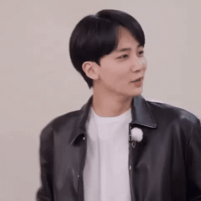 A Young Man Wearing A Black Leather Jacket And A White T-Shirt . GIF