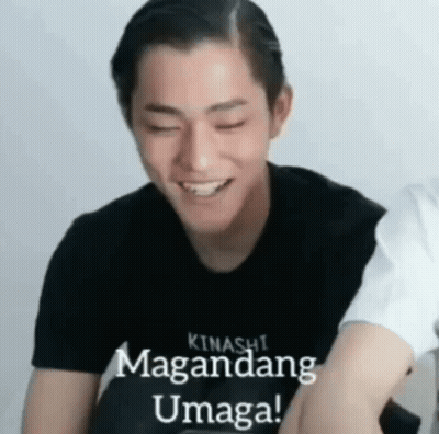 A Young Man Wearing A Black Shirt Is Smiling With His Eyes Closed And The Words `` Kinashi Magandang Umaga '' Written On GIF
