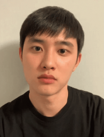 A Young Man Wearing A Black Shirt Looks At The Camera With A Serious Look On His Face GIF