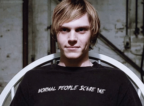 A Young Man Wearing A Black Shirt That Says Normal People Scare Me GIF