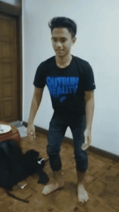 A Young Man Wearing A Black Shirt That Says " Outrun Reality " GIF