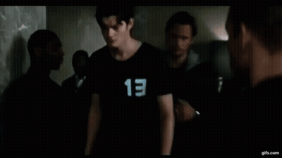 A Young Man Wearing A Black Shirt With The Number 13 On It . GIF