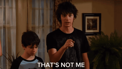 A Young Man Wearing A Black T-Shirt That Says ' Nirvana ' On It GIF