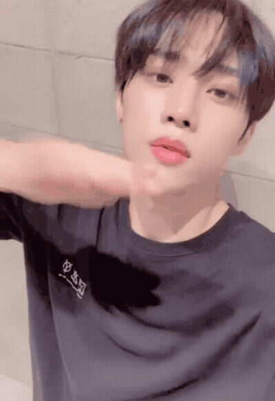 A Young Man Wearing A Black T-Shirt With Chinese Characters On The Front GIF