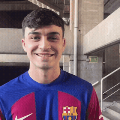A Young Man Wearing A Blue And Red Fcb Shirt Smiles GIF