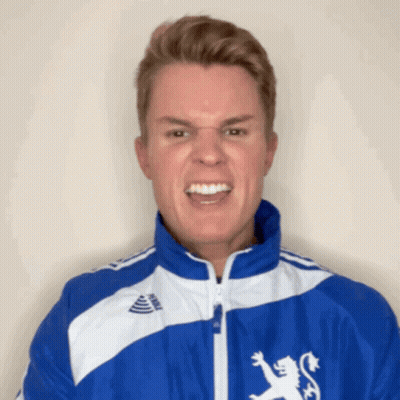 A Young Man Wearing A Blue And White Jacket With A Lion On It GIF