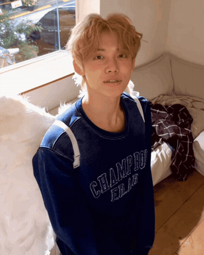 A Young Man Wearing A Blue Champion Sweater GIF
