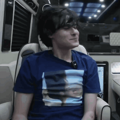 A Young Man Wearing A Blue Shirt With A Picture Of A Man On It GIF