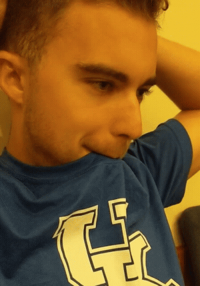 A Young Man Wearing A Blue Shirt With The Letter G On The Front GIF