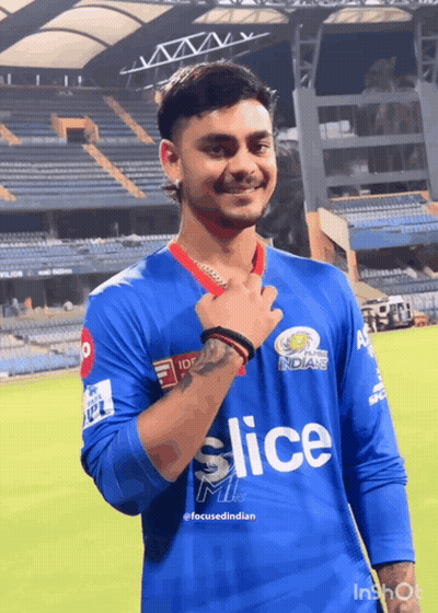 A Young Man Wearing A Blue Slice Jersey Stands On A Field GIF