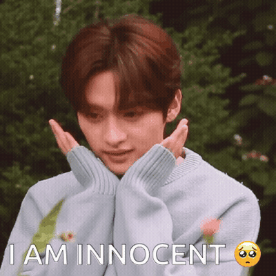 A Young Man Wearing A Blue Sweater Is Making A Sad Face And Says I Am Innocent GIF