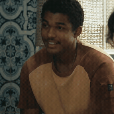 A Young Man Wearing A Brown And White Shirt With The Word Puma On The Arm GIF