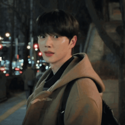 A Young Man Wearing A Brown Coat And A Hooded Jacket GIF