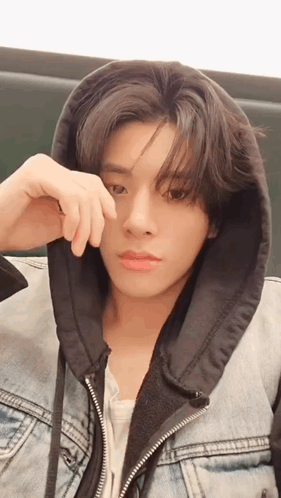 A Young Man Wearing A Denim Jacket With A Black Hood Covering His Face GIF