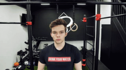 A Young Man Wearing A Drink Your Water Shirt GIF