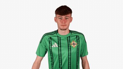 A Young Man Wearing A Green Adidas Shirt Covering His Ears GIF