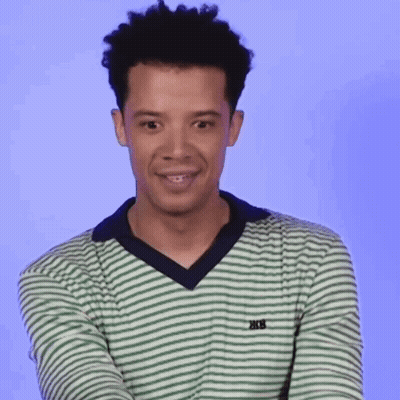 A Young Man Wearing A Green And White Striped Shirt With The Word Trek On The Front GIF