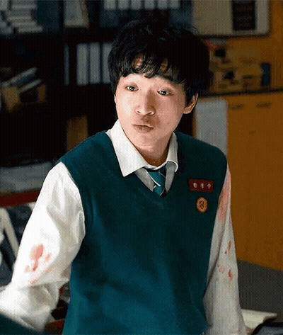 A Young Man Wearing A Green Vest And Tie Has Blood On His Sleeves GIF